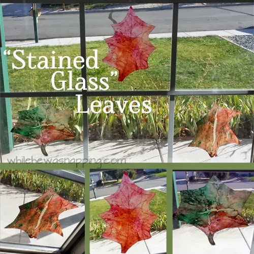 stained glass leaves on a window made from crayon and wax paper that are green, brown, and red.